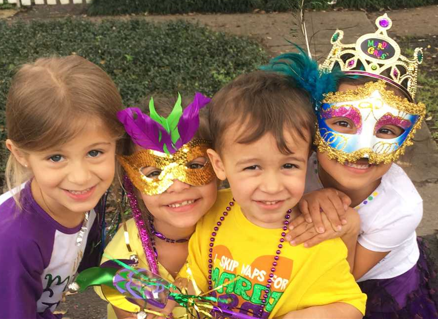 Children in fun Mardi Gras colors.